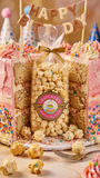 Popcorn cake with 'Happy Birthday' banner and Hatchers Popcorn Company logo.