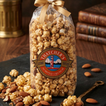 Bag of Hatchet's popcorn with almonds on a dark slate surface