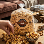 Bag of Thatchers popcorn with scattered popcorn and almonds on a wooden table.