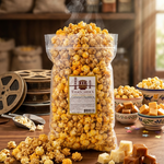 Bag of Thacher's Caramel Cheddar popcorn on a wooden table with caramel pieces and popcorn scattered around.