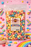 Bag of colorful Thatcher's Uni-Korn popcorn on a pink background with rainbow decorations.