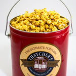 Red bucket filled with popcorn and a label for Thatcher's Popcorn on a white background