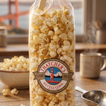 Bag of Thatcher's kettle corn on a wooden table with a scenic background