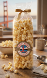 Bag of Thatcher's kettle corn on a wooden table with a scenic background