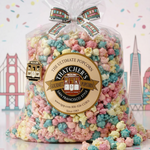 Bag of colorful popcorn with Thacher's Gourmet Popcorn label on a decorative background