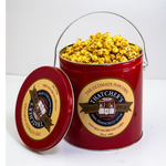 Red tin filled with popcorn and branded lid on a white background