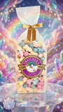 Bouquet of colorful popcorn in a clear bag with a gold bow against a vibrant, multicolored background.